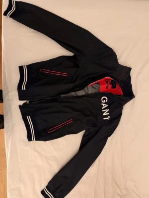 Svart vindjacka från GANT, strl M - En skaljacka från gant, aldrig använd. Lappen är fortfarande kvar. Nypris 2499, mitt pris 800. Kan fraktas, priset kan också diskuteras. kom dm för övriga frågor!