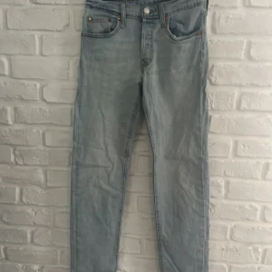 Levis 501 ljusblå jeans straight fit - Ljusblå Levis 501 jeans som är försmå för mig väldigt fina tyvärr ett litet hål som syns på sista bilden annars väldigt fina jeans. 90cm höga och 30cm bredd 