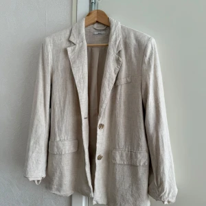 Kavaj i linnematerial från Gina Tricot - Kavaj från Gina. Ni får ursäkta att den är ostruken på bilden hehe! I jättebra skick annars, men just denna har en tefläck vid ena ärmen som säkert går att få bort med något medel. Ni kan DMa för närbild.