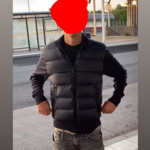 Svart dunvästjacka från Tom Ford - Säljer en svart dunvästjacka från Tom Ford med quiltad framsida och släta ärmar. Västen har dragkedja framtill, två fickor med dragkedja och en diskret logga på ärmen. Perfekt för dig som vill ha en stilren och exklusiv look. Original pris 24 999 kronor!