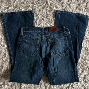 Lee jeans - Lee jeans med medelhög midja och bootcut form. Jättefint skick och snygga fickor som gör att rumpan ser dunder ut!