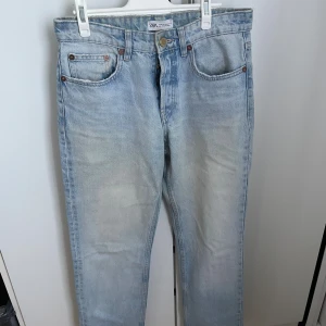 Zara jeans  - Säljer ett par ljusblå jeans från Zara med klassisk femficksdesign och knappstängning. Jeansen har rak passform och normal midja. Säljer då de inte kommer till användning, är i ett fint skick!