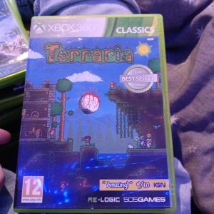 Terraria Xbox 360 - Terraria till Xbox 360, komplett med fodral, manual och skiva. Spelet är i fint skick och klassad som 'Best Seller'. Utforska, bygg och kämpa i detta populära äventyrsspel. PEGI 12. Perfekt för samlare eller spelentusiaster.