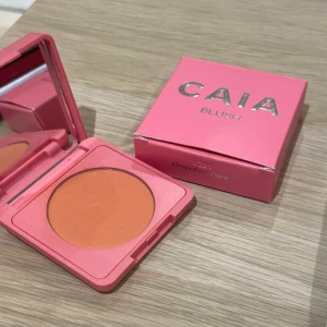 CAIA Grapefruit Juice Rouge - Säljer ett CAIA Matte Blush i färgen Grapefruit Juice. Rouget kommer i en snygg rosa fyrkantig dosa med spegel och har en matt, persikotonad nyans som ger fräsch färg till kinderna. Perfekt för dig som gillar en naturlig look med lite extra glow. Säljer eftersom det inte är min färg helt oanvänd! 