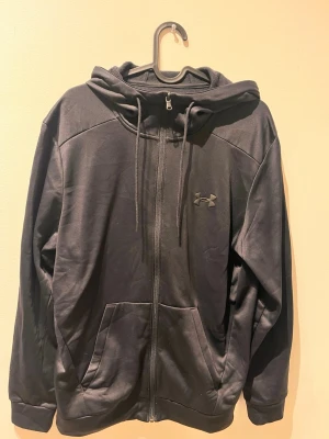 Svart Under armour hoodie  - säljer nu en under armour hoodie i storlek S, den är endast använd till gymmet max 5 gånger. Väldigt bra skick och inga defekter eller slitage! 