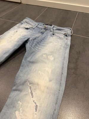 Replay Anbass - Har dessa snygga Replay anbass jeans med en fin ljus blå färg/fade och revor för extra design. Har lagat hos en skräddare under som på bilden . De är W30 och L34.                                                 Skriv gärna vid intresse 