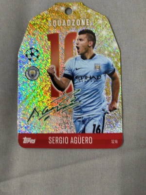 Match Attax Squadzone Sergio Agüero - Exklusiv Match Attax Squadzone-samlarbricka med Sergio Agüero från Manchester City. Glittrig design med nummer 16, autograftryck och Champions League-logga. Perfekt för fotbollssamlare och fans av trading cards. Köparen står för frakten.
