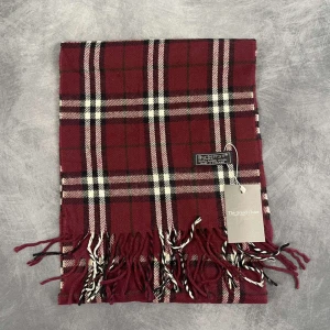 Burberry halsduk - Skick: 7/10 (Vintage), begagnad, inga defekter. | Vad som ingår: Endast halsduken. | Ordinarie pris: +- 4000 SEK / 400 €. | OBS: Halsdukarna finns i samma färgsättning men kan skilja sig något i modell eller detaljer, beroende på tillverkningsår eller kollektion.