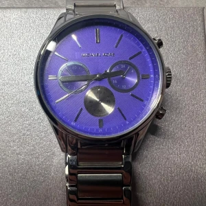 Michael Kors klocka med lila urtavla - Stilren Michael Kors klocka i silverfärgat metallarmband och rund boett. Urtavlan är lila med tre mindre visartavlor och tydliga silverindex. Länken har MK-logga och klockan har flera knappar på sidan för extra funktioner. Obs: behöver byta klock batteri. 