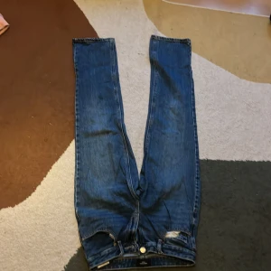 Blå jeans från Vero Moda Denim - Snygga blå jeans från Vero Moda Denim med klassisk femficksdesign och raka ben. Jeansen har normal passform och är tillverkade i slitstarkt bomullsdenim. Perfekta för dig som gillar en enkel och tidlös look.