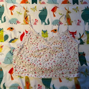 vit croptop med blommor - Säljer min supersöta croptop/linne som fungerar som en magtröja med gulliga blommor på, så fin på sommaren när man är brun
