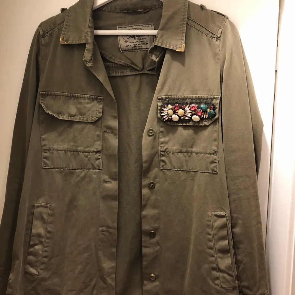 Militärgrön jacka med detaljer på fickan och kragen. Använd enstaka gång, som ny.. Jackor.