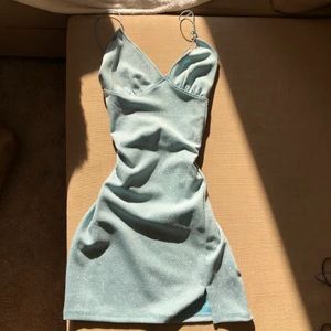 Blå Glittrig Klänning  - En jätte fin pastell blå glittrig klänning. Den är ännu finare i verkligheten då den glittrar fint i solen. Kan användas till festen men också dagligen. 