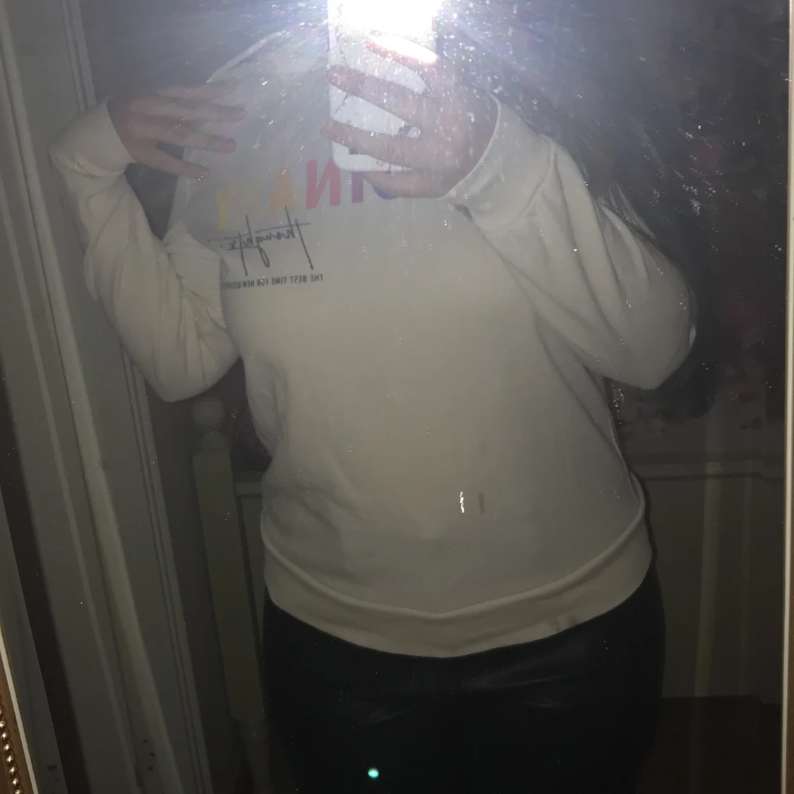 White huddie with text on