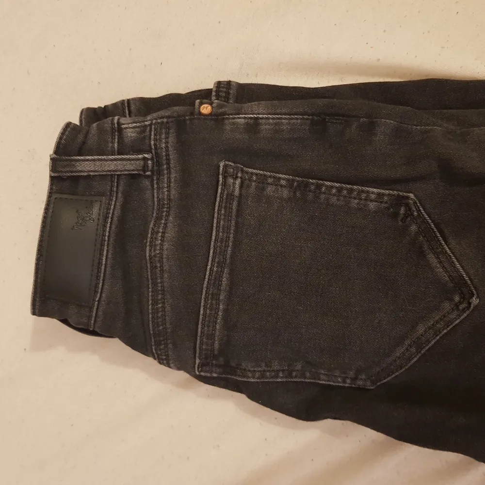 Ett par jeans som har hål i knäna och säljs för att de inte används . Jeans & Byxor.