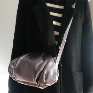 Silver/metallic väska  - Säljer denna jätttefina metallic väska som jag fick i present då den ej går att lämna tillbaks och inte riktigt är min stil,  aldrig använd! Köp direkt för 265!