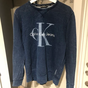 Calvin Klein Jeans tröja strl L  - Säljer en blå Calvin Klein tröja i fint skick. Storlek Large men ganska liten i storleken så sitter perfekt på mig som är 186cm och vanligtvis har small/medium. Mötes upp i centrala Linköping eller så postas tröjan. Vid det senare alternativet står köparen för frakten. 