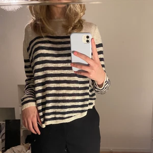 Blå och vitrandig tröja - Säljer denna jättefina randiga tröja som jag har köpt secondhand. Ränderna ser svarta ut men är egentligen mörkblåa. Tröjan är tunn och lite genomskinlig.❗️Nopprig och hänger vissa trådar här och var, har även ett hål vid axeln, skriv privat för mer bild