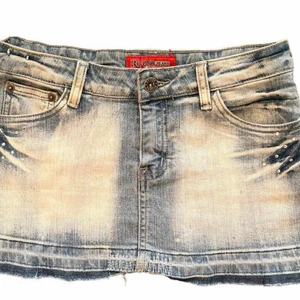 Minikjol i jeansmaterial - Thrifted y2k inspirerad jeanskjol i mini-modell. Med kristall detaljer, sjukt snygg nu till sommaren. Köpt från depop från Lettland. Såhär skrev säljaren i deras annons: Waist is 35cm, length is 29cm and width at the bottom is 43cm😊