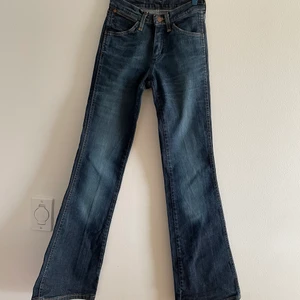 Wrangler midwaist jeans  - Wrangler mid/lowwatisted jeans i snygg blå färg. Älskar dem, men har aldrig kunnat använda dem då jag köpte dem second hand där man inte kunde prova, och de är för små för mig :(. Midjemått 26 (lågmidjat) och skulle säga att längden motsvarar en 32. Fint skick, lite stretchigt material och snygga bakfickor! Kan skicka mot fraktkostnad eller möta upp i Lund 💗💗💗 (ifall många är intresserade kan det bli budgivning) 