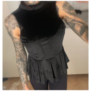 Nelly - Svart sammetstopp, strl XS - Svart sammetstopp från Nelly, dragkedja i bak. Storlek XS.