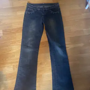 Säljer dessa fina svarta jeans med detaljer fram och bak. Köpte ifrån Vinted men är bara testade 1 gång. De är i modellen boot/flare. I sten har lossnat där fram men det är inget man tänker på!