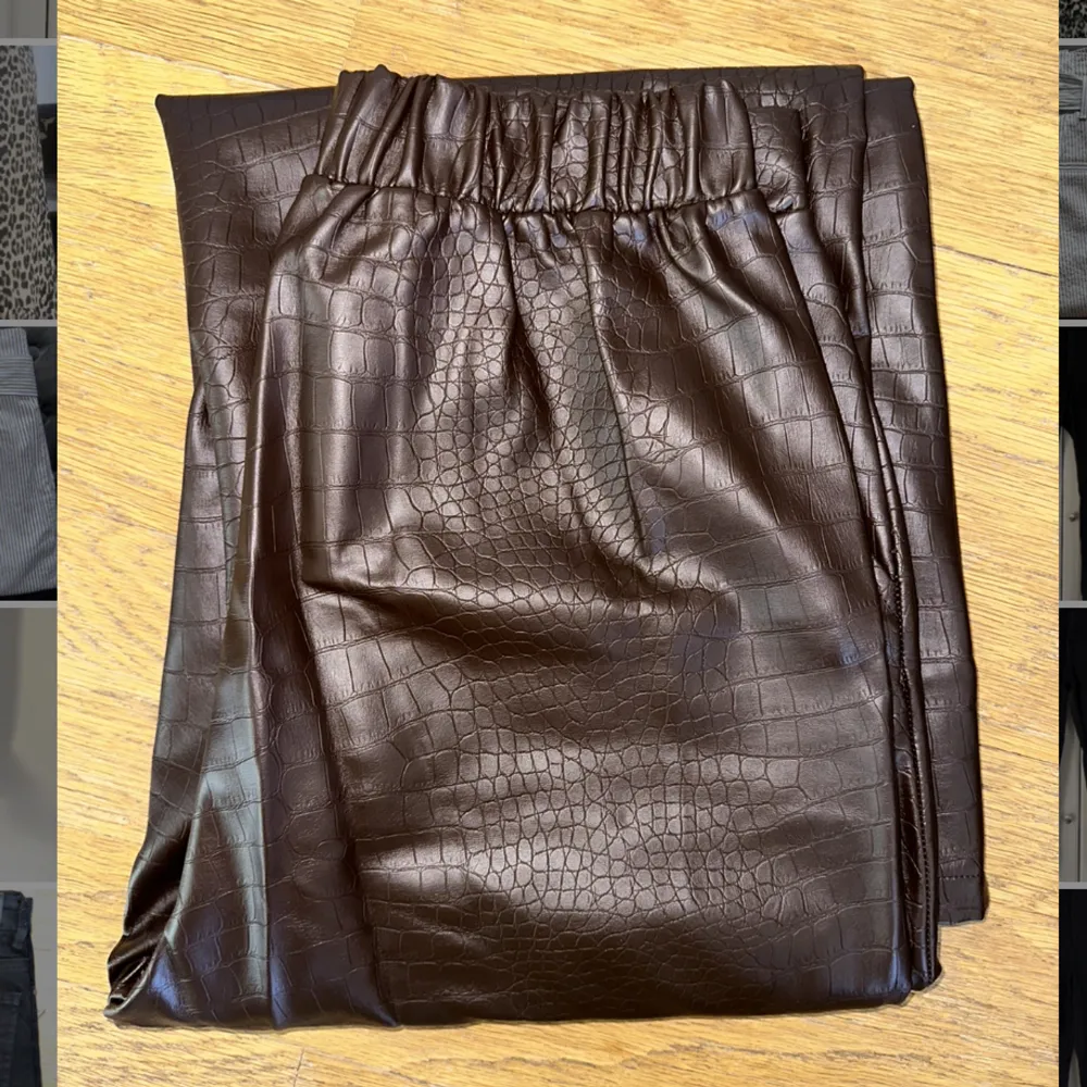 Brun läderbyxa av PU-material strl 40. Ormskinsmönstrade. Vid & rak modell, inköpt på ASOS. Obetydligt använda. . Jeans & Byxor.