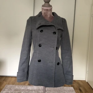 Kappa  - Kort kappa i grå