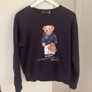 Polo by Ralph Lauren Bear  - Marinblå polo by Ralph Lauren. Gott skick. Ny pris 1300kr  Liten i storleken.
