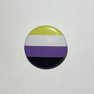 ickebinär pin - liten ickebinär pin! :) 💛🤍💜🖤 jag säljer den för 5kr + 15kr frakt med swish, eller använd köp nu!