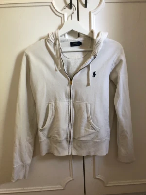 Ralph Lauren tröja - Säljer en vit Ralph Lauren tröja pga för liten. Lite uttvättad men går absolut att använda och är fortfarande fin.