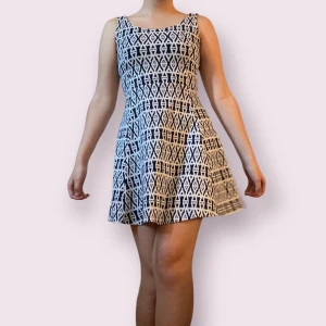 Vitblå mönstrad klänning  - Fin sommarklänning i jättebra skick köpt på H&M collection ”DIVIDED” för ca 6 år sedan! Öppen bakdel. (95% polyester, 5% elastan)