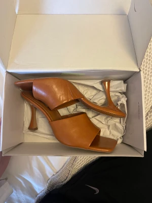 Bruna klackskor - Bruna klackskor från nakd. Lite skinkinnanlår material men är gjort på polyuretan. Storlek 40 och endast använda en gång inomhus. Säljer då jag inte hann lämna tillbaka i tid