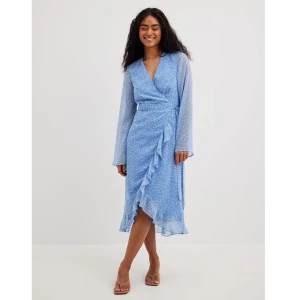 Blå vit blommig klänning storlek 36 - En blå vit omlottklänning från NA-KD i storlek 36. Aldrig använd, endast tvättad en gång! Nypris hos NA-KD är 549kr.  Upplever den som lite stor över bysten, kan eventuellt passa en liten 38. Klänningen är äkta omlott, dvs. man knyter den helt själv!