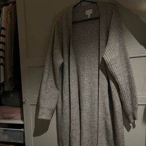 Lång stickad kofta ifrån H&M - Säljer pågrund av dubbletter. Storlek S andvänd få gånger. 