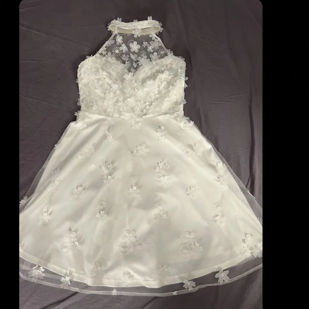 Vit blommig klänning från bubbleroom i storlek 34. Klänningen är köpt för 1000kr men säljs för 450kr! Använd 2 gånger.. Klänningar.