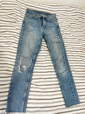 Gina tricot mom jeans - Jeans från Gina tricot med slitningar och många knappar