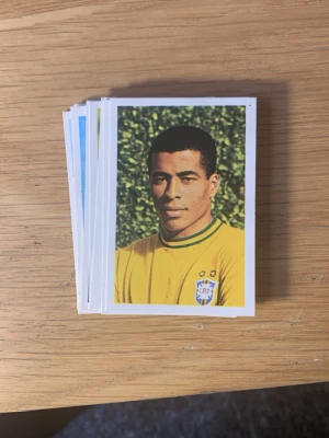  1970 VM Fotbollskort  - Säljer en bunt 14st klassiska  Fotbollskort med färgporträtt av olika spelare från olika länder. Bilderna har vit ram och retrostil, flera med landslagströjor i gult, blått, grönt och rött. Perfekt för dig som gillar fotbollshistoria och samlarobjekt.