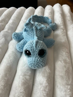 Ljusblå virkad drake🩵🩵 - Denna söta drake letar efter sitt nya framtida hem🩵🩵 Denna är virkad med kärlek, jag älskar att virka🩵🥰 Den är virkad av mjukt garn från Rusta, hårda ögon som inte går att ta av. Den är cirka 50cm lång om man sträcker ut svansen🐉