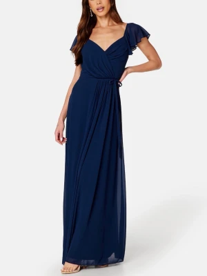 Mörkblå långklänning med omlott - Lång mörkblå klänning med omlottdesign och v-ringning. Klänningen har korta volangärmar och ett knyt i midjan som både kan knytas fram eller bak. Den är använd en gång och är i nyskick. Köpt ifrån Zalando men från märket Bubbleroom. 