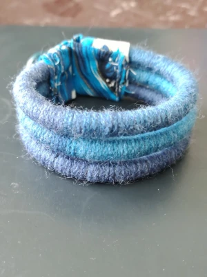 Armband med 3 rader - Snyggt armband i 3 rader med knapp stängning. Handgjort i garn. Ca 18 cm långt 