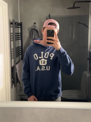 Polo hoodie usa  - En fett Polo USA hoodie. Passar bra till alla tillfällen som nu till sommaren och våren. Små defekter på bild 4-5 men inget som syns. Finns även pytte små lila fläckar som inte syns alls. Modellen är 178cm och 67kg passar riktigt bra. Pris pga defekterna👍🙏