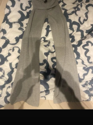 Grå utsvängda yogapants - Snygga grå yogapants med utsvängda ben och låg midja. Byxorna är i mjukt och stretchigt material, perfekta för en avslappnad stil. Passar dig som gillar bekväma och trendiga plagg. Helt nya.