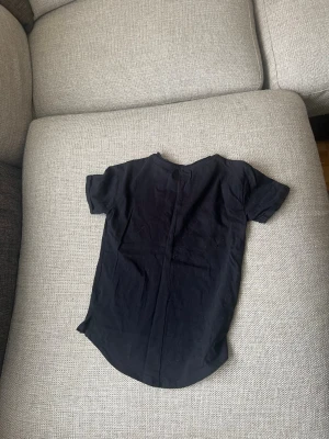 Svart t-shirt från D.A.D - En enkel svart t-shirt från D.A.D med rund hals och korta ärmar. Tillverkad i mjuk bomull och har en klassisk passform som funkar till det mesta. Perfekt basplagg för alla tillfällen.