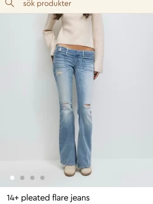 Ljusblå pleated flare jeans - Säljer ett par ljusblå jeans med bootcut, flare passform, low waist säljer dessa jeans då dem är för stora och inte passar.