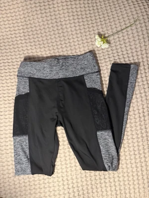 Träningstights med fickor - Supersnygga leggings från SHEIN i gråmelerat och svart. Hög midja och åtsittande passform, perfekta för träning eller chill. Tillverkade i stretchigt material som ger skön rörelsefrihet och sitter snyggt på kroppen.