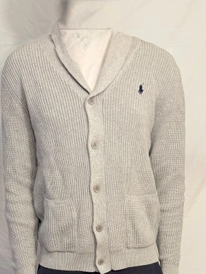 Ralph Lauren tröja - Ljusgrå Ralph Lauren stickad kofta med knappar framtill och två fickor. Pris går och diskuteras