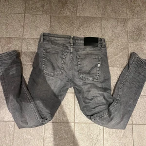 Grå superskinny jeans från Dondup - Säljer ett par grå jeans från Dondup, modell IRIS med superskinny fit. Jeansen har klassisk femficksdesign, dragkedjegylf och snyggt tvättad finish. Perfekta för dig som gillar en tight och modern look.