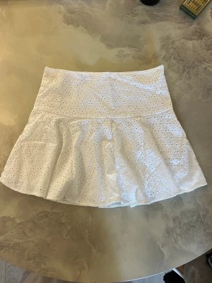 Vit volangkjol i bomull - Söt vit kortkjol med volang och broderade detaljer från H&M. Storlek 36. Väldigt fint skick🌸