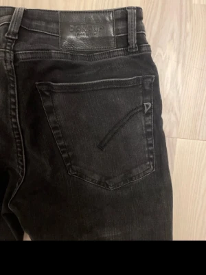 Svarta skinny jeans från Dondup - Snygga svarta skinny jeans från Dondup med klassisk femficksdesign och diskret logga på bakfickan. Perfekta för en trendig och avslappnad stil.